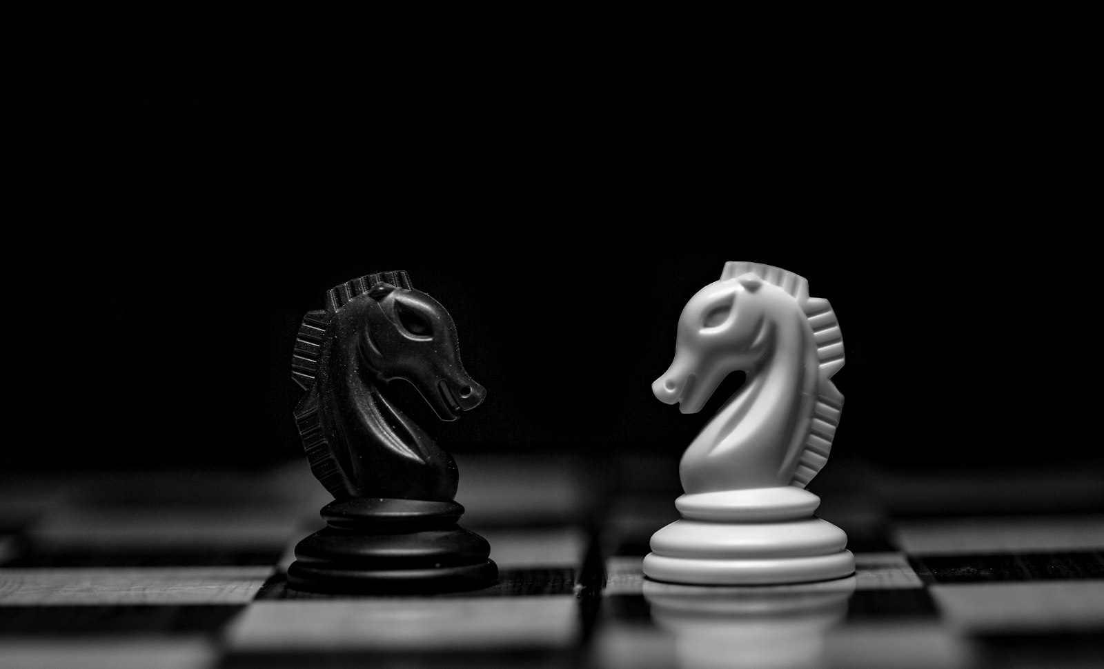 Black and white chess knights facing off, representing executive cyber risk